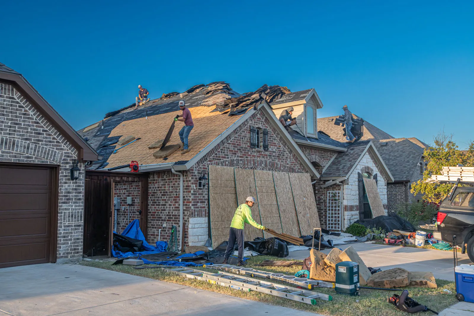 Summit roofing crew completing a full roof replacement on a brick home